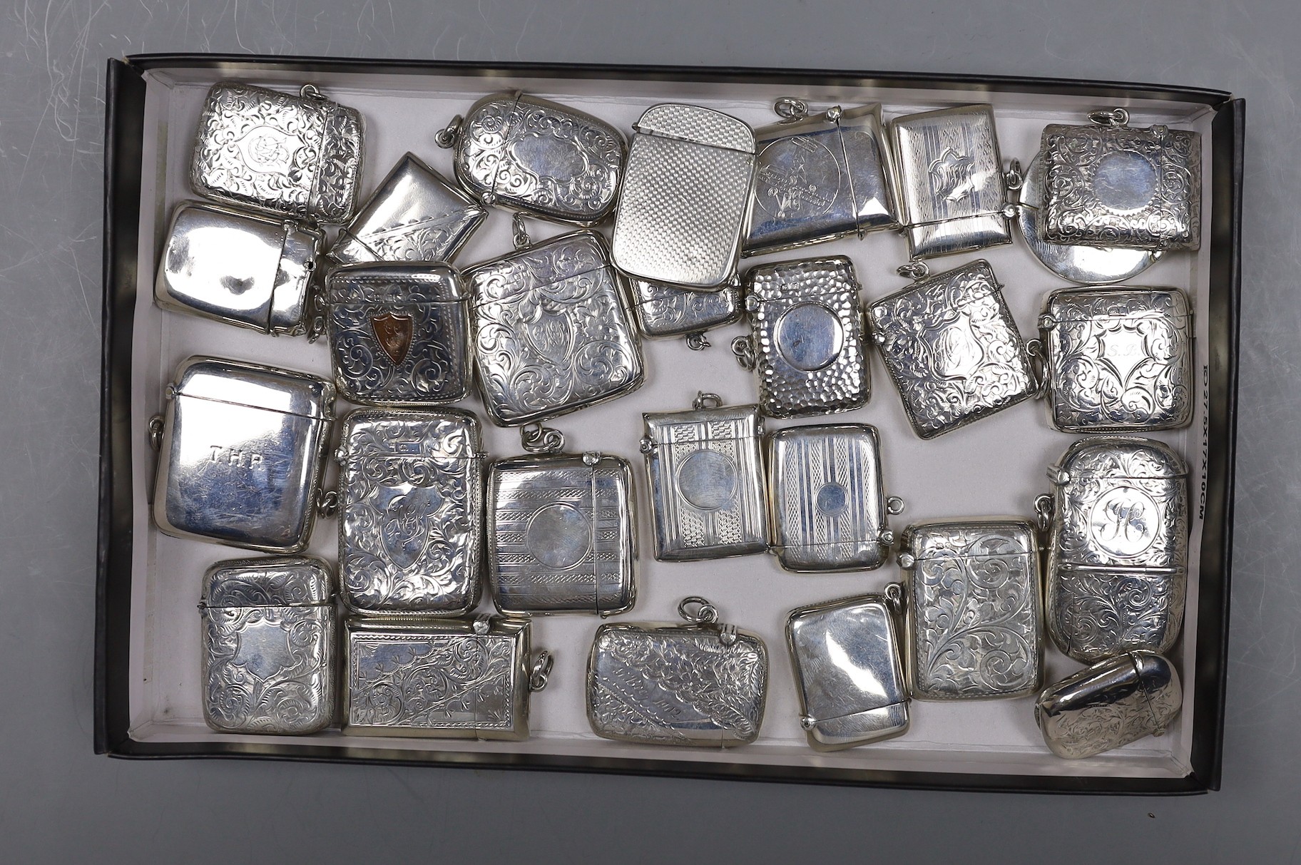 A collection of twenty six mainly early 20th century silver vesta cases and one combination vesta/sovereign case, William Neale, Chester, 1899.